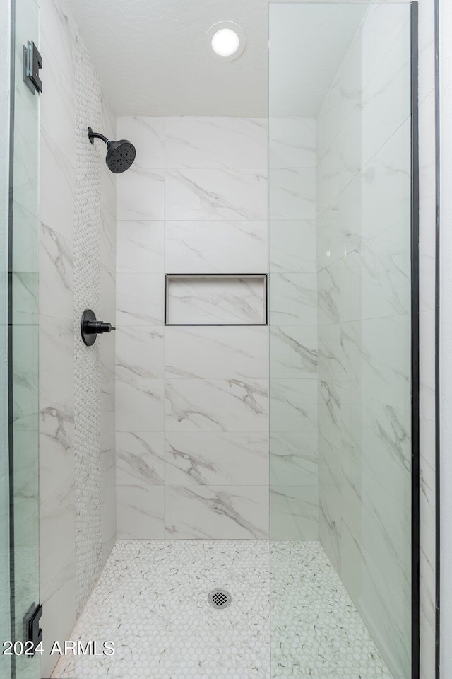 bathroom with tiled shower