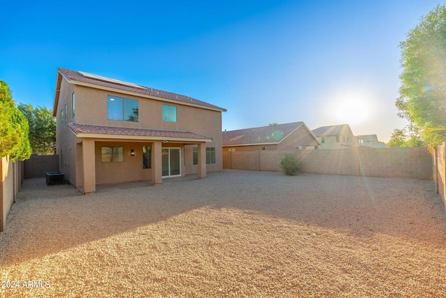 rear view of property with a patio and central AC