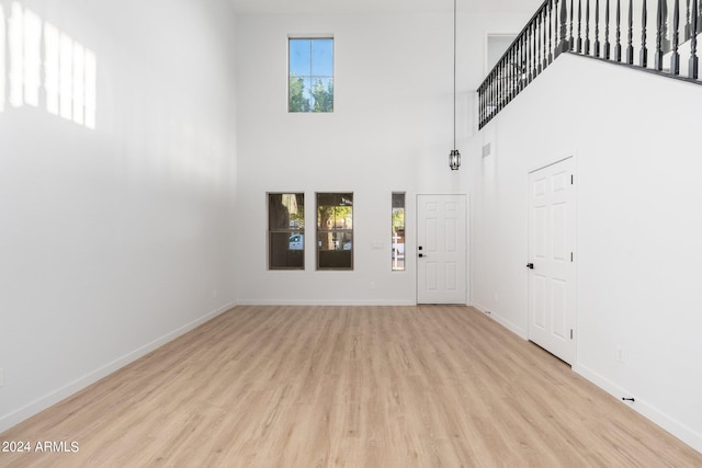 foyer featuring light hardwood / wood-style flooring and a high ceiling