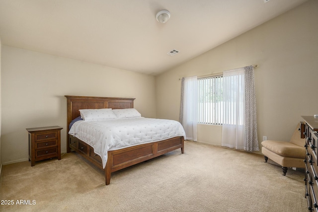 bedroom featuring lofted ceiling and light colored carpet