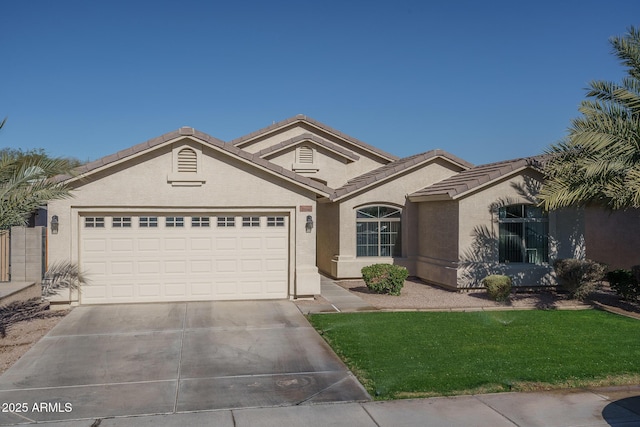 view of front of house featuring a front yard and a garage