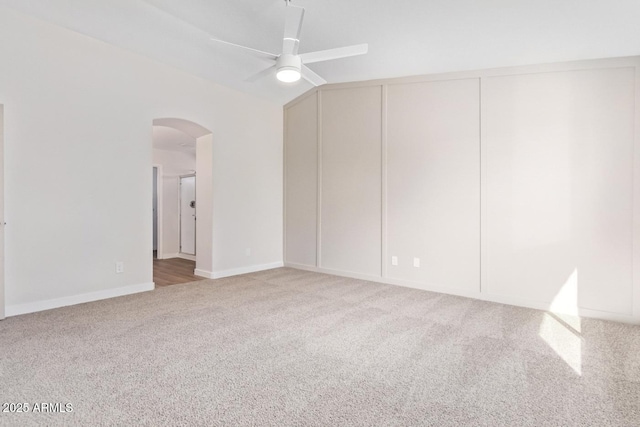 spare room featuring ceiling fan, lofted ceiling, and carpet floors