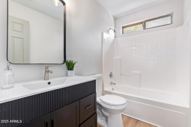 full bathroom with shower / tub combination, hardwood / wood-style floors, vanity, and toilet