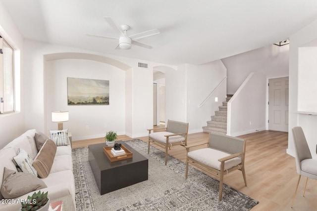 living room featuring ceiling fan and light wood-type flooring