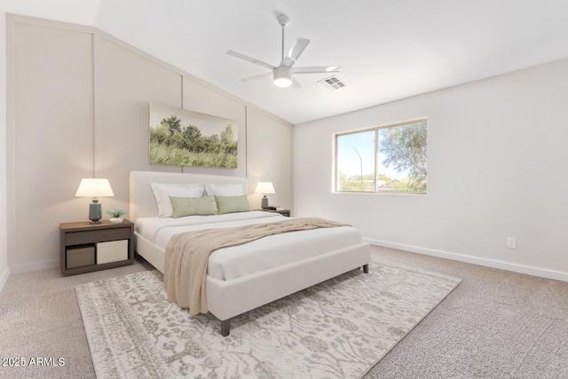 carpeted bedroom with ceiling fan and vaulted ceiling