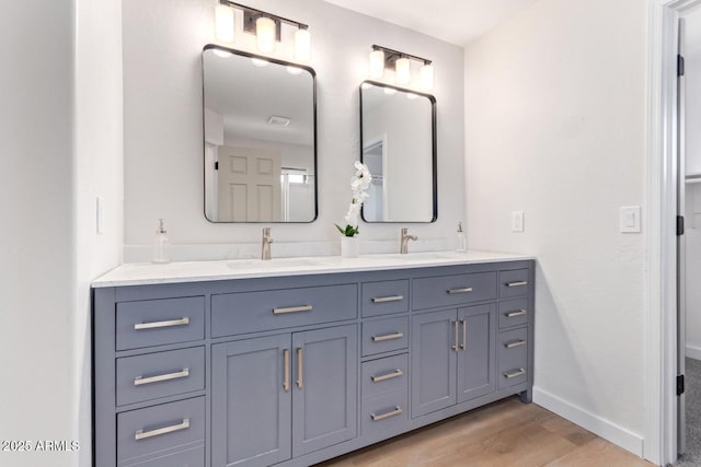 bathroom with vanity and hardwood / wood-style flooring