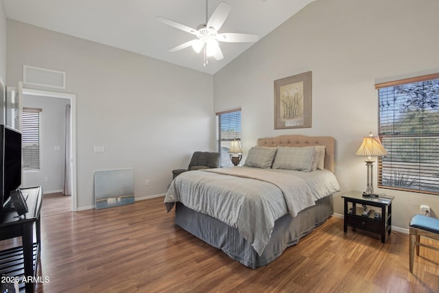 bedroom with high vaulted ceiling, baseboards, visible vents, and wood finished floors