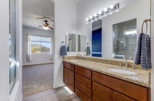 bathroom featuring vanity, ceiling fan, and walk in shower