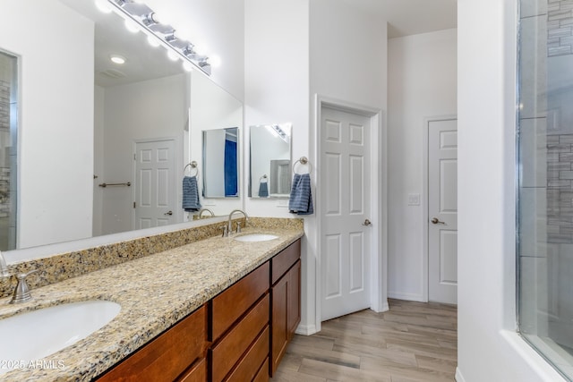 bathroom with vanity and hardwood / wood-style floors