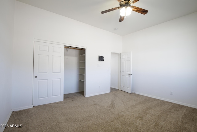 unfurnished bedroom featuring light carpet, a closet, and ceiling fan