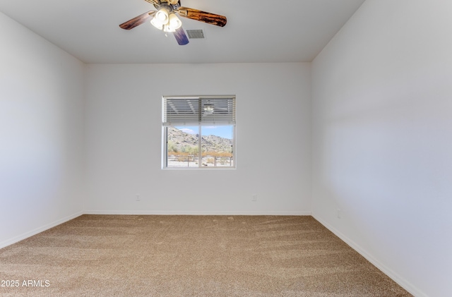 spare room featuring carpet floors and ceiling fan