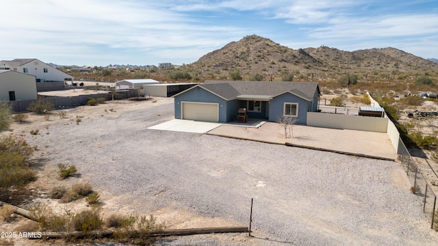 view of front facade with a garage and a mountain view