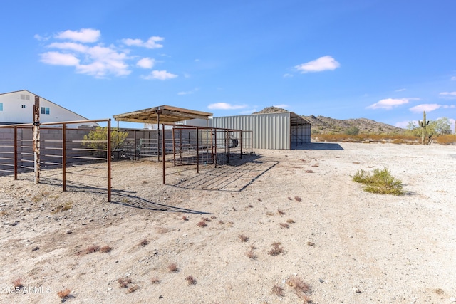 view of yard with a mountain view and an outbuilding