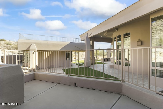 view of patio featuring a balcony