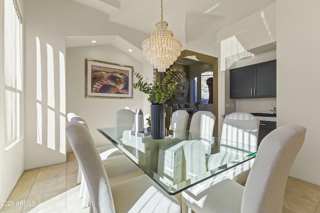 dining space with light tile patterned floors, an inviting chandelier, and vaulted ceiling