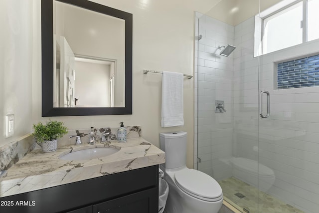 bathroom featuring vanity, toilet, and an enclosed shower