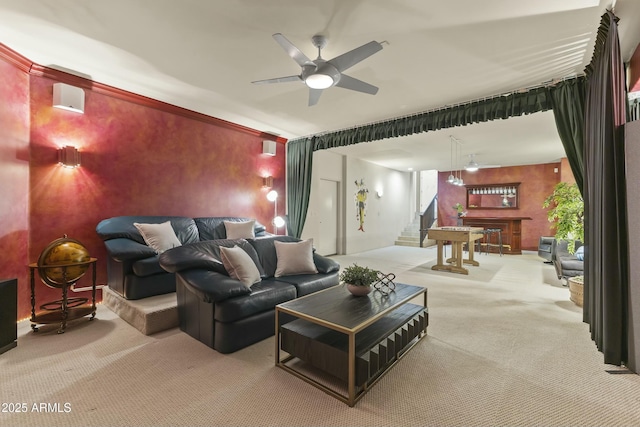 carpeted home theater room with ceiling fan