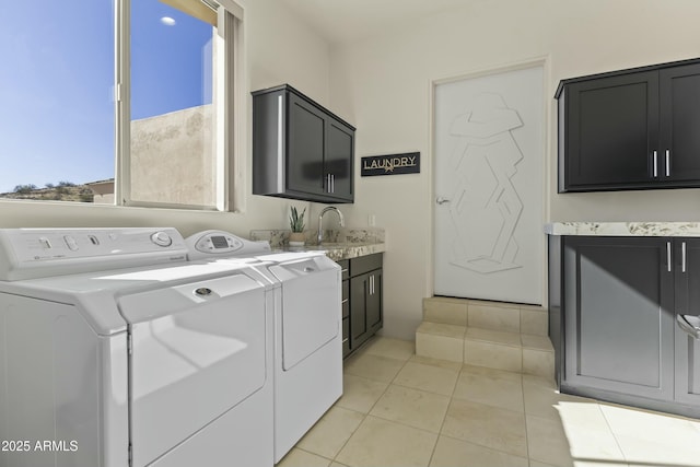 laundry room featuring cabinets, separate washer and dryer, sink, and light tile patterned floors