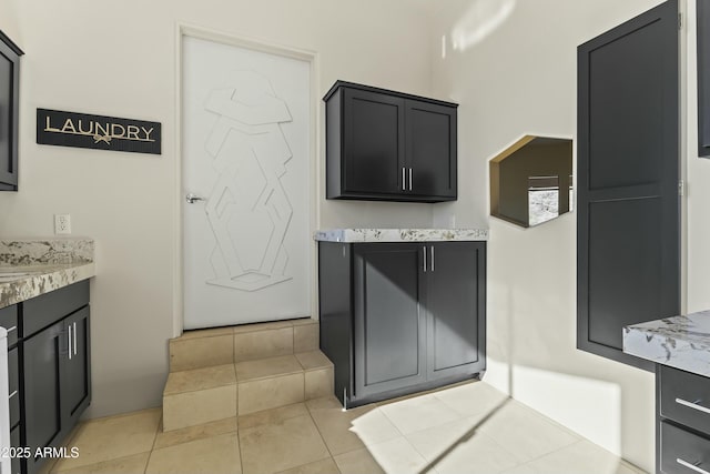 kitchen with light stone countertops and light tile patterned floors