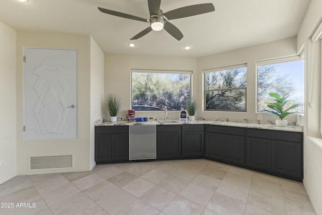 kitchen featuring light stone countertops, light tile patterned floors, ceiling fan, and sink