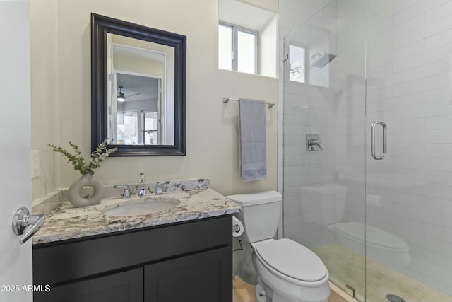 bathroom with vanity, toilet, walk in shower, and ceiling fan