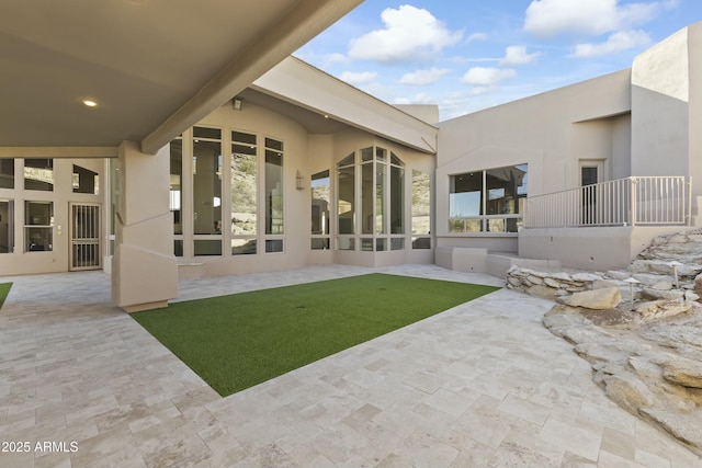 back of house with a patio