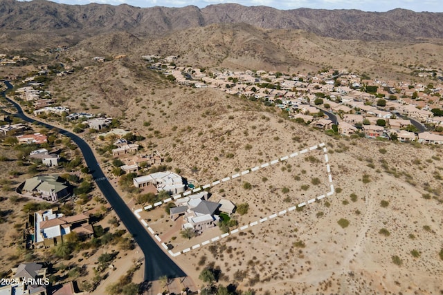 birds eye view of property with a mountain view