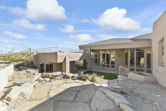 back of property with a patio