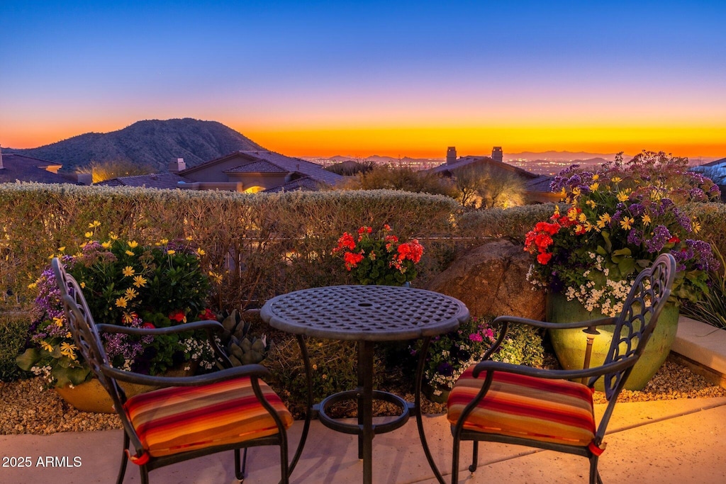 patio terrace at dusk featuring a mountain view