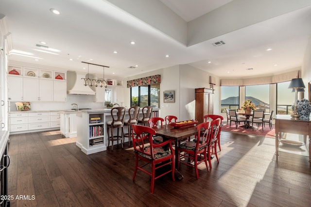 dining area with dark hardwood / wood-style flooring, sink, and a mountain view