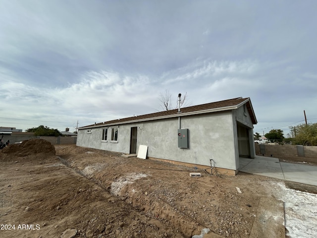 rear view of house featuring a patio area and electric panel