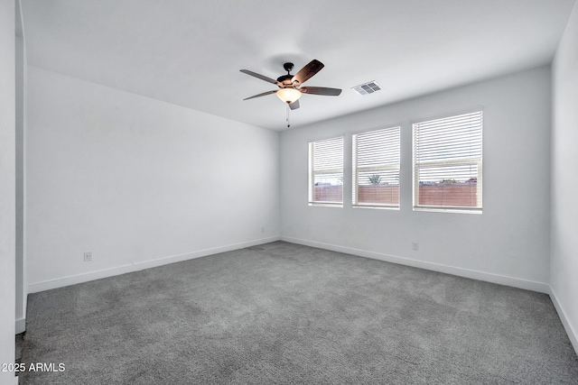 unfurnished room featuring dark colored carpet and ceiling fan