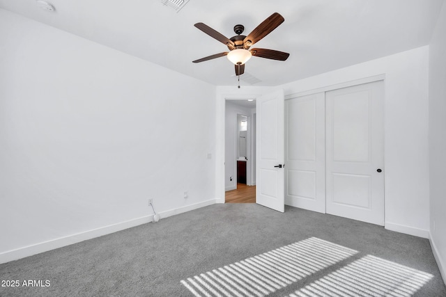 unfurnished bedroom with ceiling fan, light colored carpet, and a closet