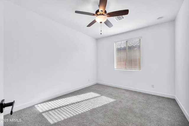 carpeted spare room with ceiling fan