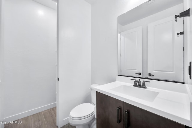 bathroom featuring toilet and vanity