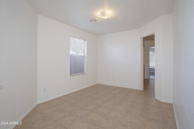 spare room featuring light tile patterned floors