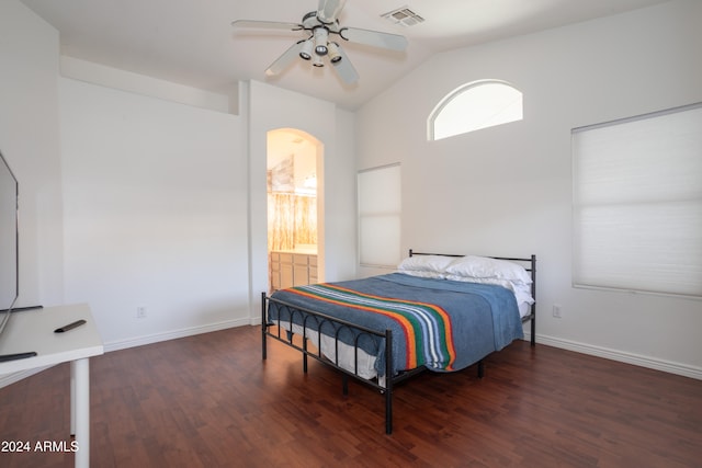 bedroom featuring ceiling fan, dark hardwood / wood-style flooring, lofted ceiling, and ensuite bath