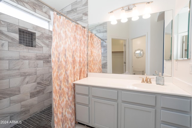 bathroom featuring a shower with curtain, vanity, and tile patterned flooring