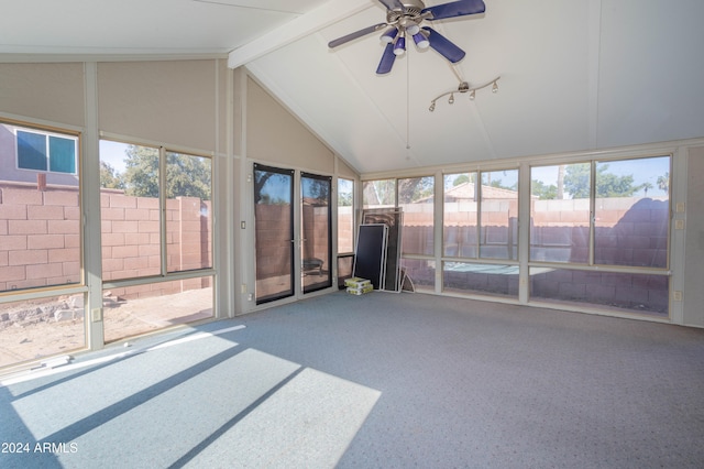 unfurnished sunroom with vaulted ceiling with beams, plenty of natural light, and ceiling fan