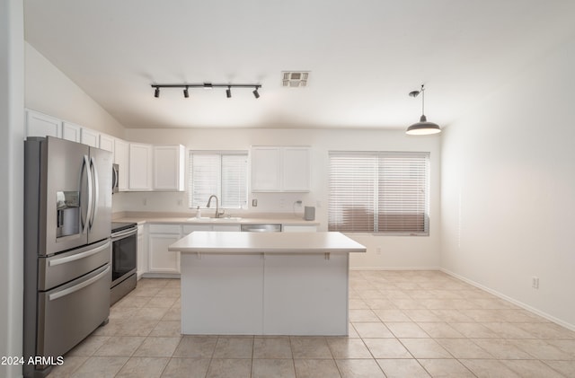 kitchen with white cabinetry, a center island, stainless steel appliances, and decorative light fixtures