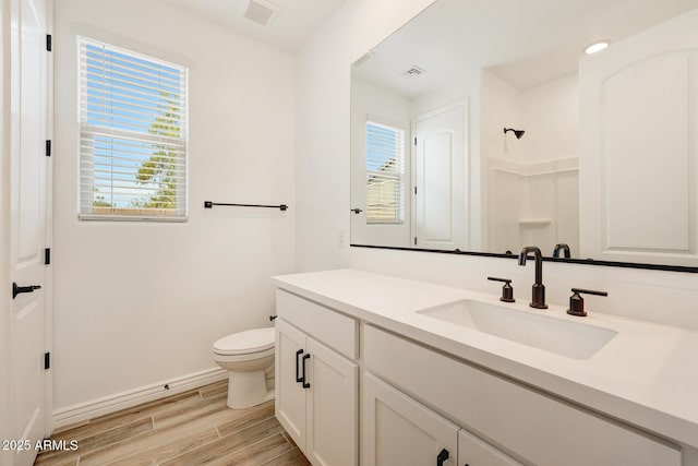 14742 W Lariat Trl, Surprise, AZ 85387 - bathroom with vanity, toilet, wood finished floors, and baseboards