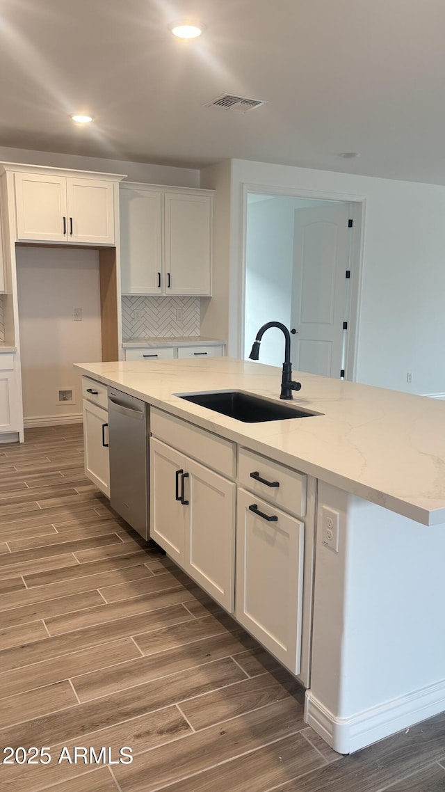 14742 W Lariat Trl, Surprise, AZ 85387 - kitchen with dishwasher, a sink, wood finished floors, white cabinets, and recessed lighting