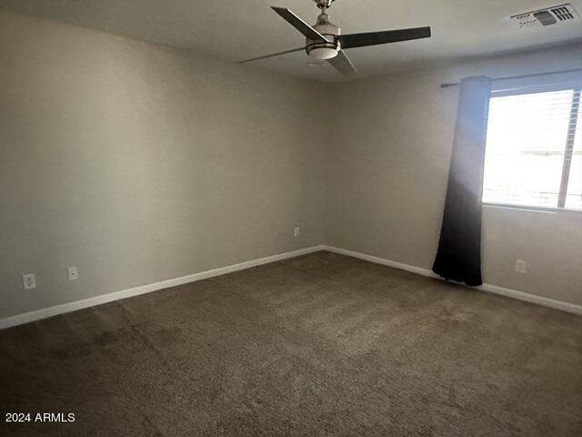 empty room featuring ceiling fan and carpet flooring