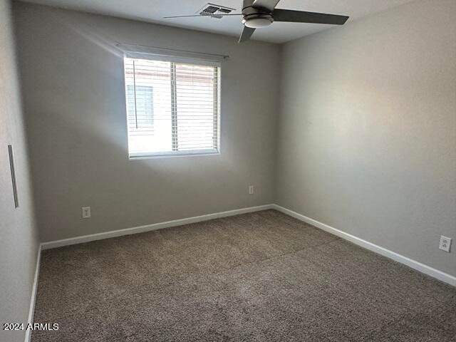 unfurnished room featuring carpet and ceiling fan