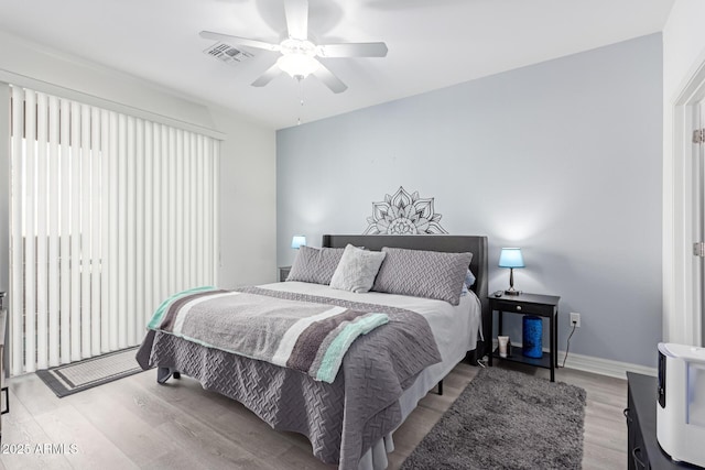 bedroom featuring light hardwood / wood-style floors and ceiling fan