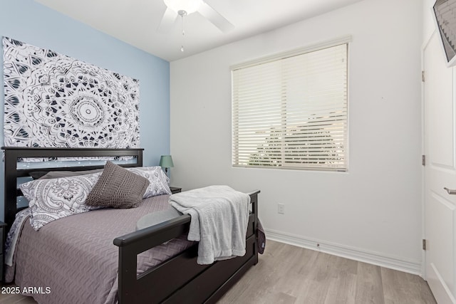 bedroom with ceiling fan and light hardwood / wood-style floors