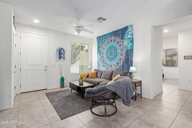 living room featuring light tile patterned floors and ceiling fan