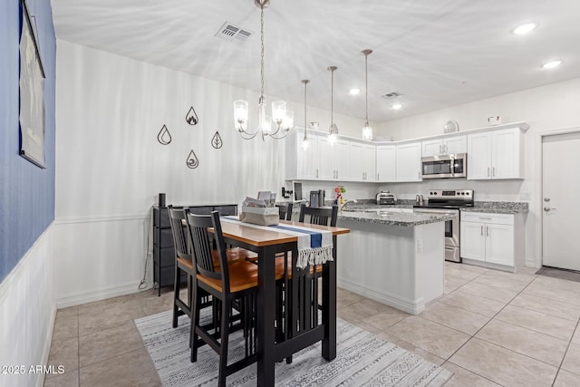 dining room with light tile patterned floors and a chandelier