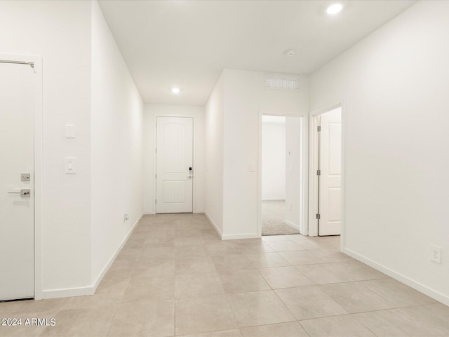 hall featuring light tile patterned floors