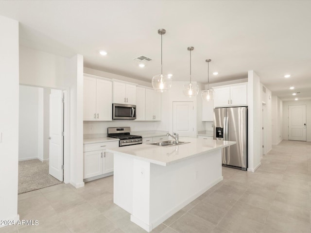 kitchen with white cabinetry, a kitchen island with sink, stainless steel appliances, and sink